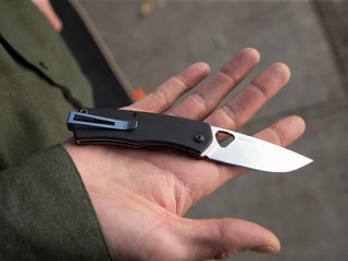 The Folsom EDC folding liner lock pocket knife clip up in black and stainless in hand.
