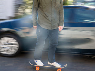 A man skateboarding with the Folsom EDC folding liner lock pocket knife in his pant pocket.