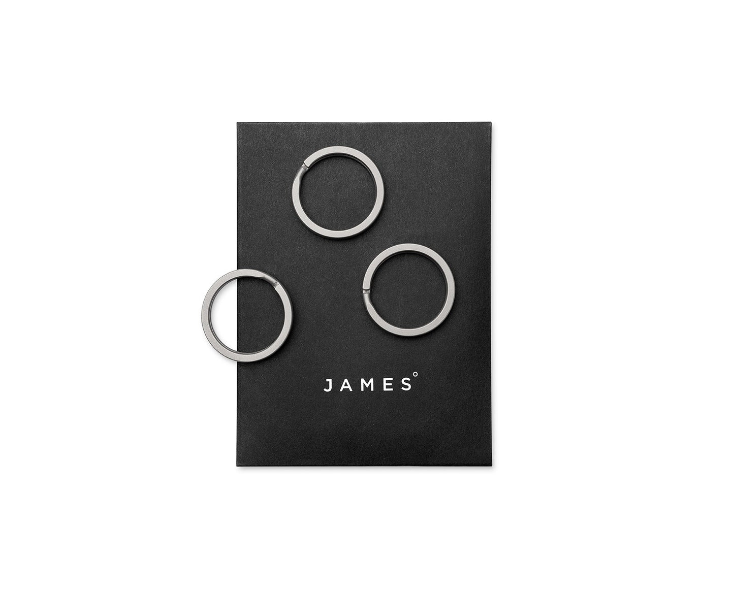 Three titanium key rings on their packaging.
