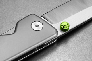 The pivot and thumbstud of the Chapter 2 EDC frame lock titanium folding pocket knife.