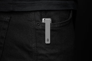 The Chapter 2 EDC frame lock titanium folding pocket knife in a pocket.