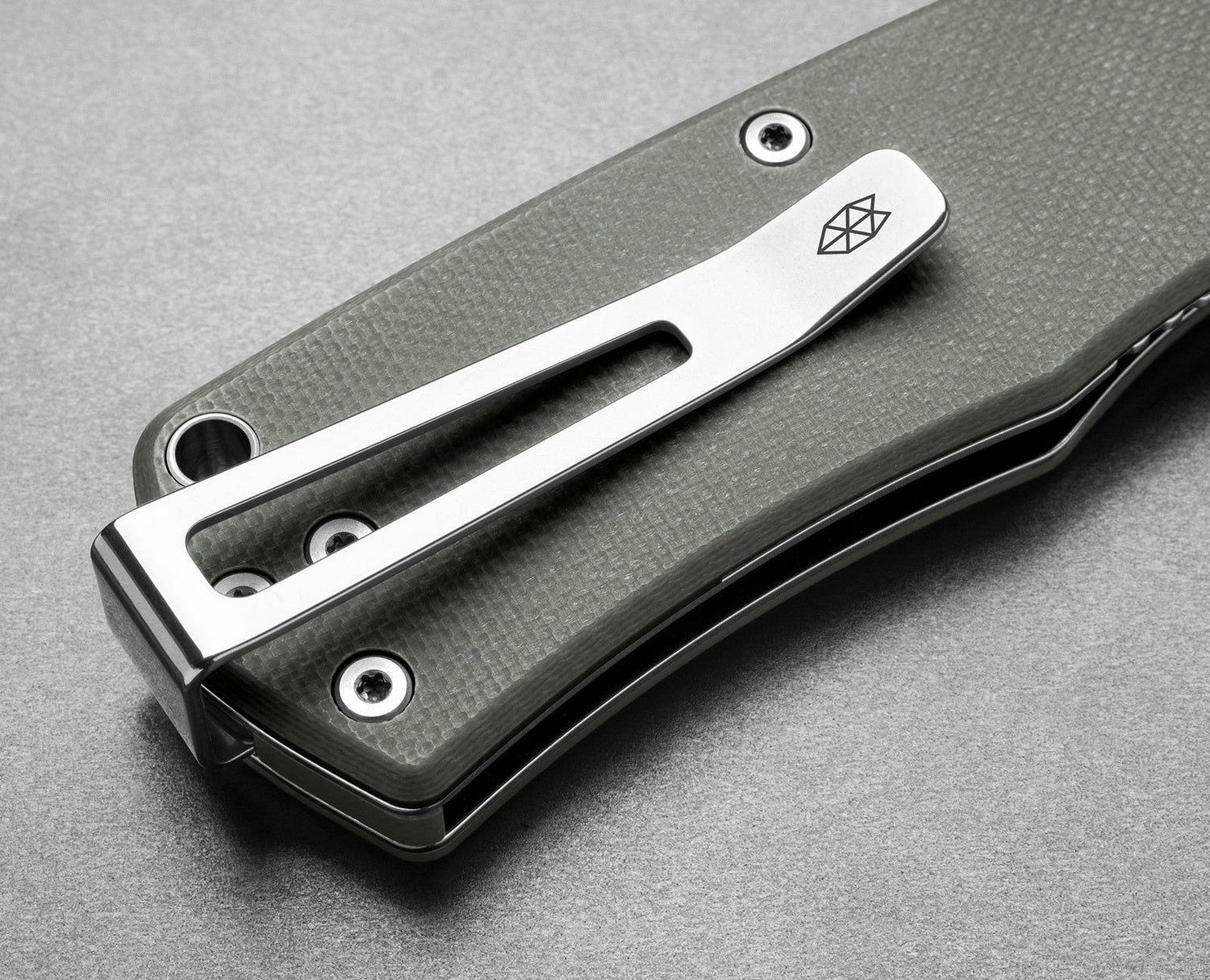 The clip of The Folsom EDC liner lock folding pocket knife with a primer gray handle.