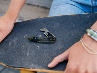 The Halifax EDC keychain multitool on a skateboard.