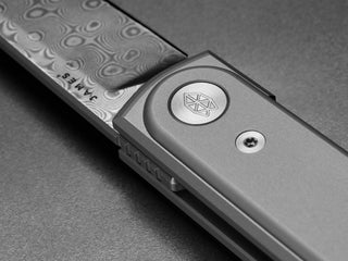 The Duval classic EDC flipper folding pocket knife with a Damascus blade.