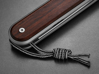 The rosewood handle of The Duval classic EDC flipper folding pocket knife.