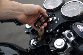 A man with his motorcycle keys on the Hardin EDC keychain carabiner.