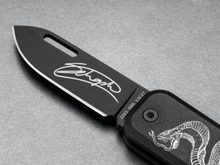 The James Brand and Schoph collab Elko EDC keychain pocket knife with a signed blade.