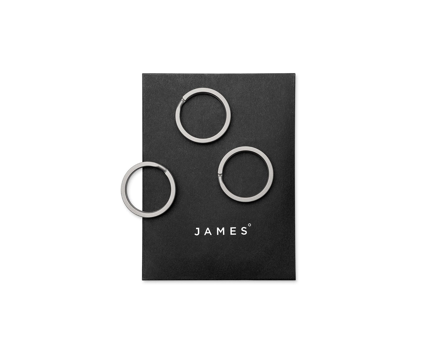 Three titanium key rings on their packaging.