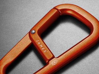 A detailed shot of The Hardin EDC keychain carabiner in orange.