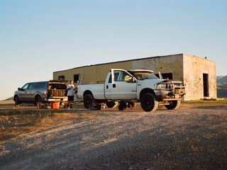 Artist Jess Mudgett preparing to paint a mural while getting supplies from his truck.