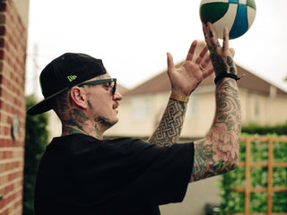 Professional barber Paul Hewitt shooting a basketball.
