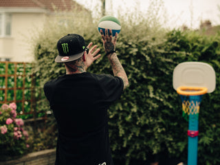 Professional barber Paul Hewitt shooting a jump shot on his sons basketball hoop.