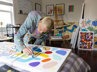 Artist Sebo Walker working on a painting.