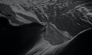 A glacier high up in the mountains.